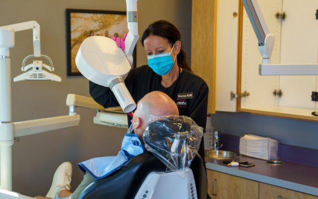 Dental Hygienist Performing Dental procedure